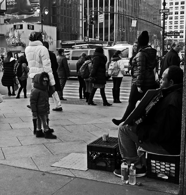 Lori George Photography - Child reading homeless mans sign asking for underwear and shoes|Macy*s 34th Street|February 2016